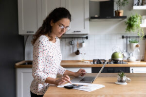 woman budgeting with a laptop