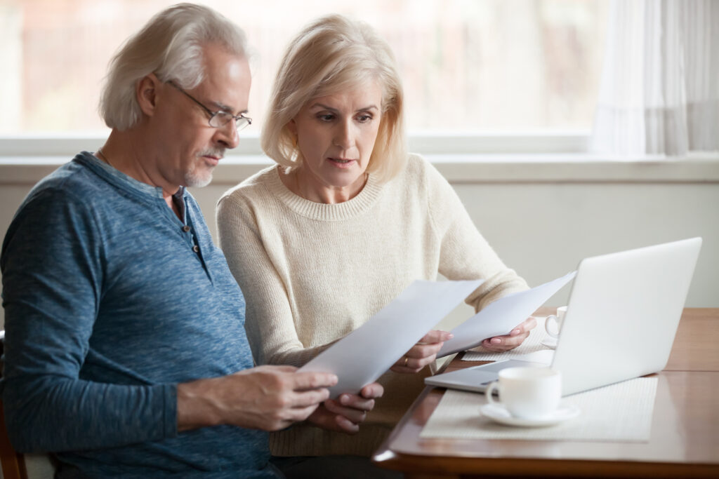 senior couple reviewing their debt management plan